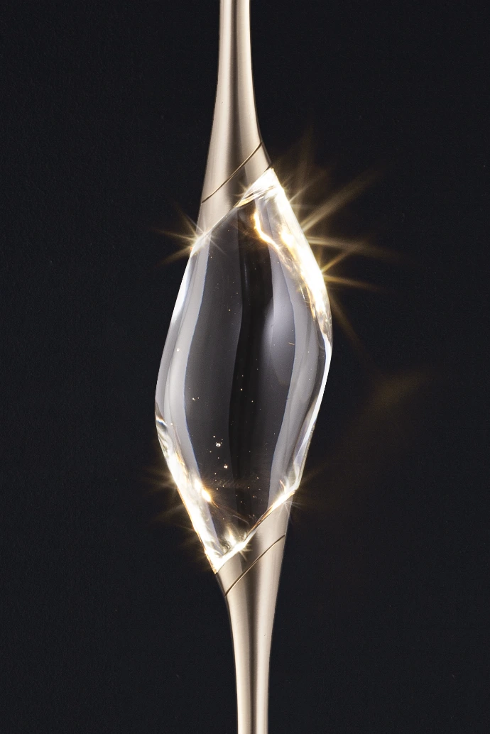 Close-up of solid crystal diffuser of Il Pezzo 12 Floor to Ceiling, showing light refraction and craftsmanship, set in cast brass structure