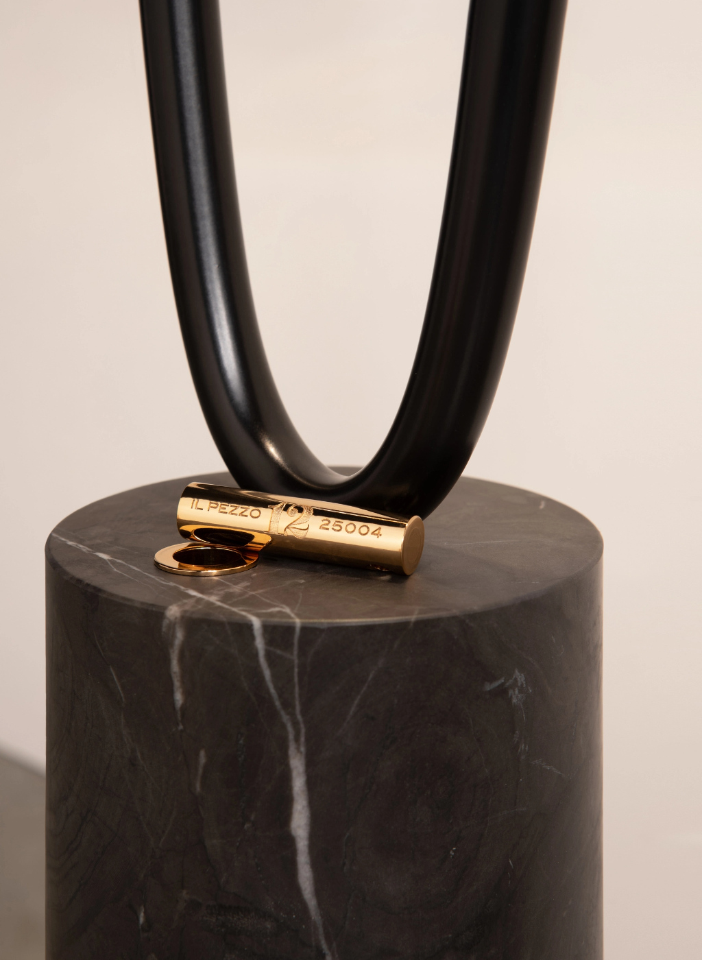 Il Pezzo 12 Floor Lamp marble base detail showing the brass cylinder with unique serial number