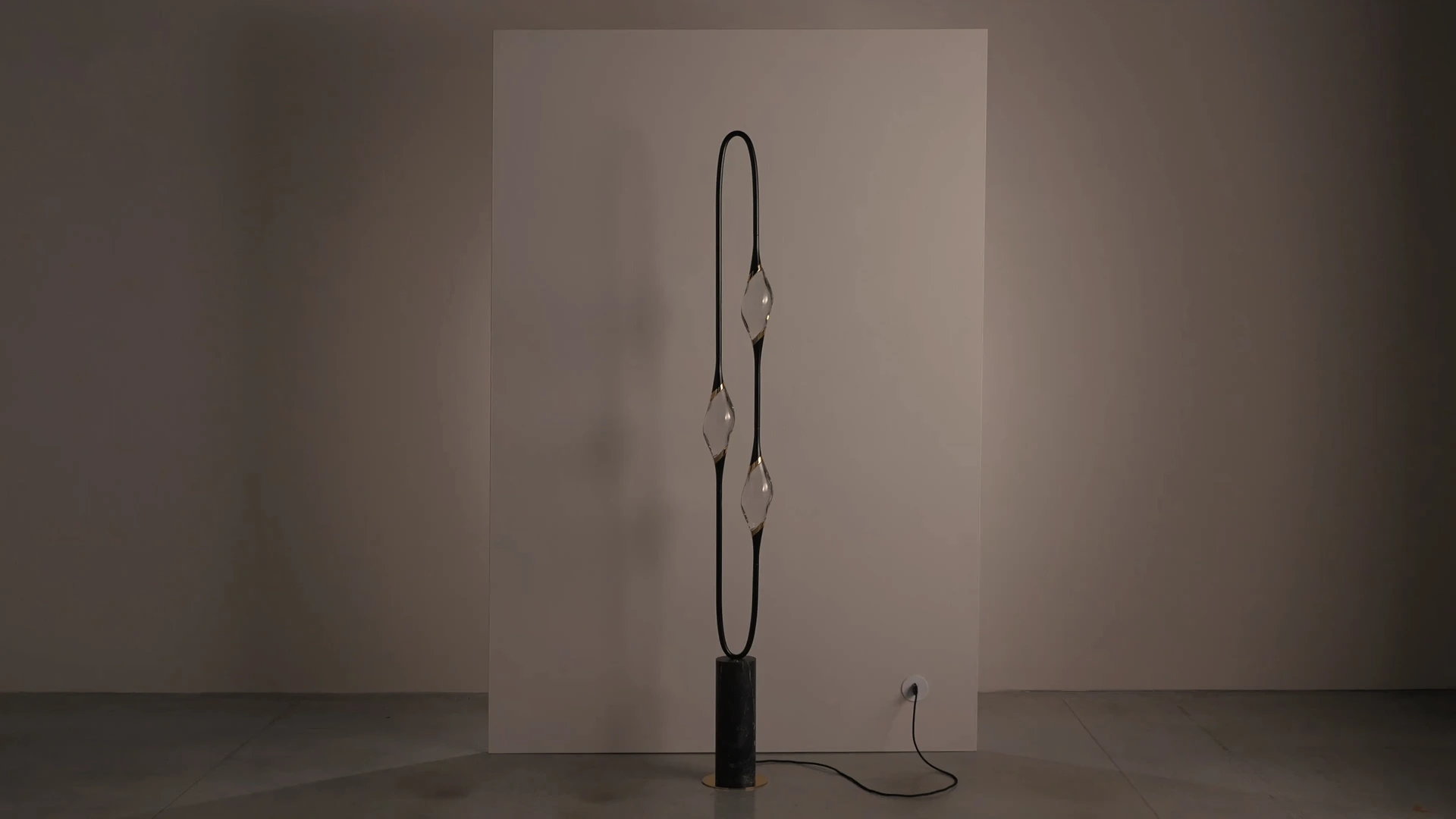 Il Pezzo 12 Floor Lamp in black and gold finish on marble base, studio photograph