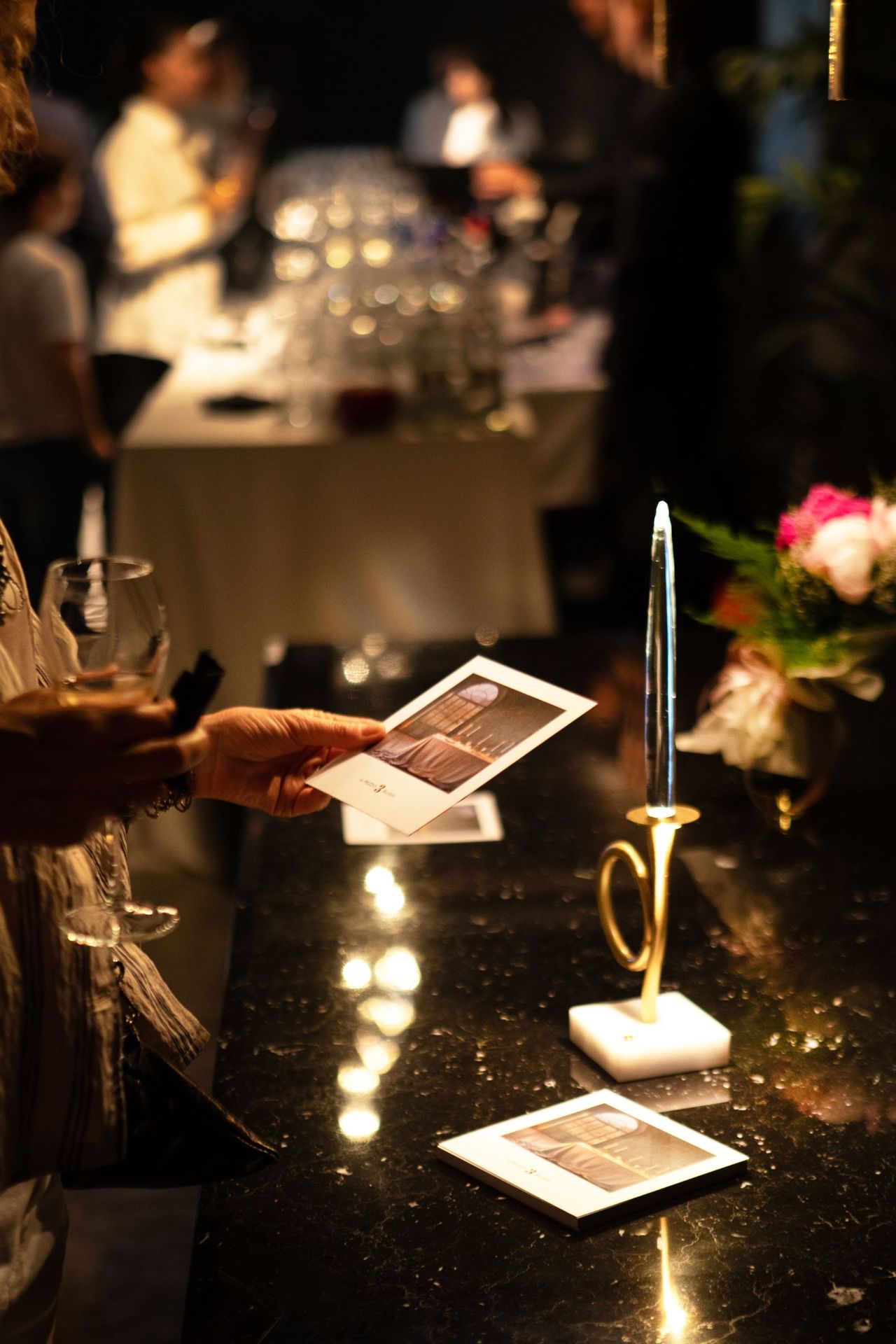 A guest reading the invitation by candlelight