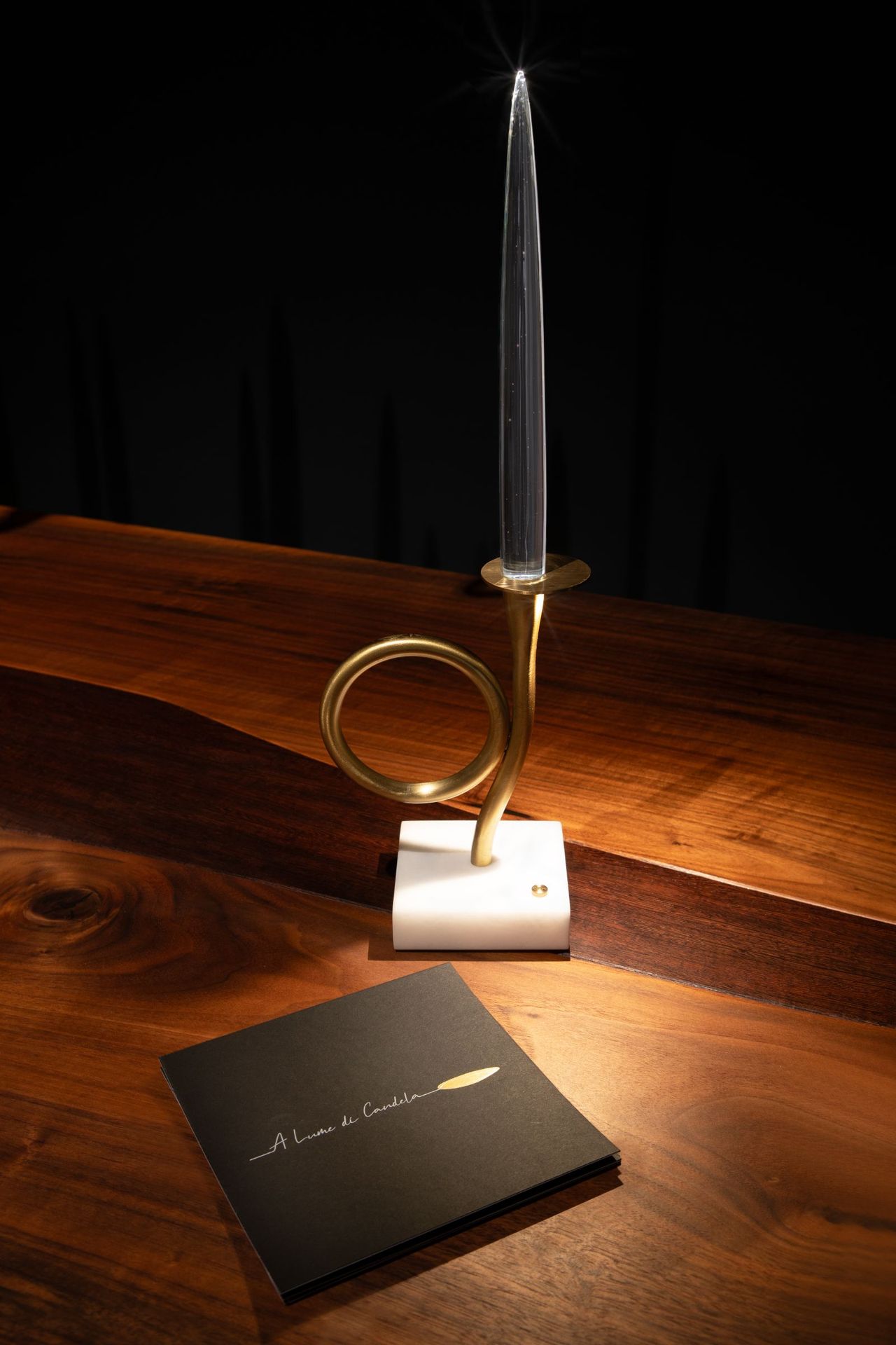 Close-up of the event invitation beside the lit piece