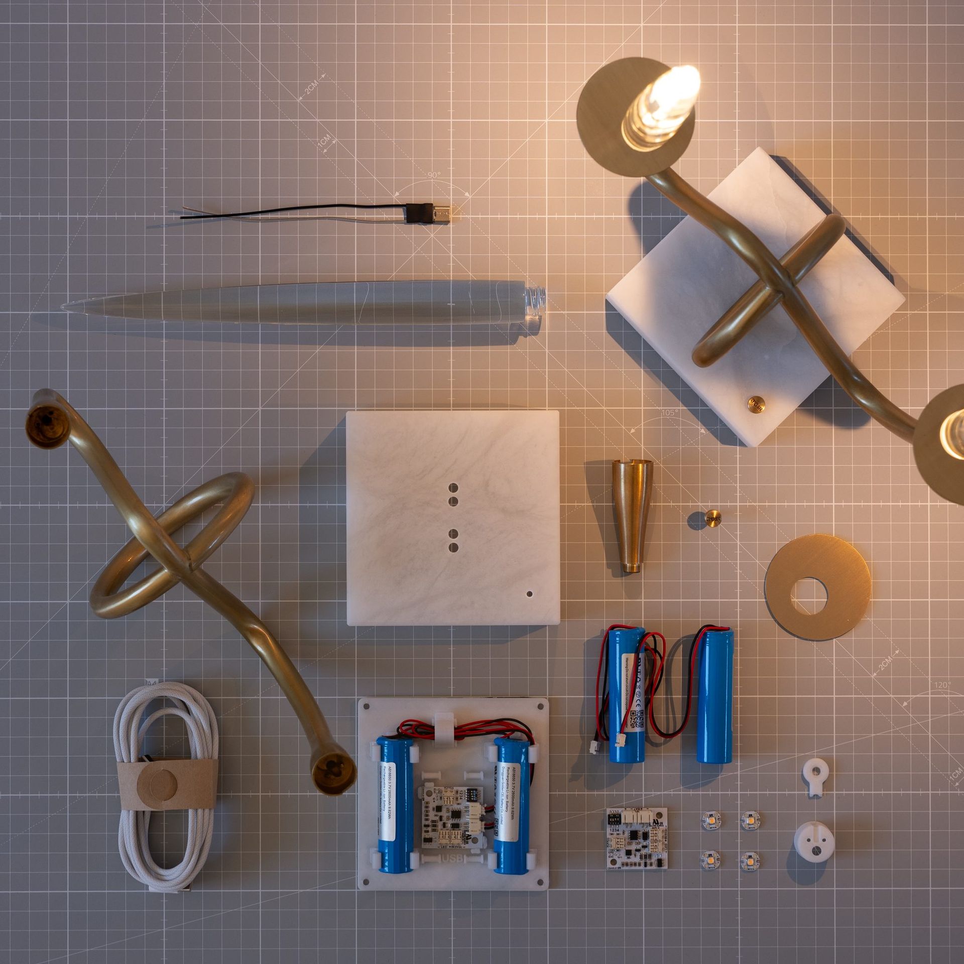Exploded view of Il Pezzo 3 Bugia — all components laid out on the assembly mat in the Florence atelier