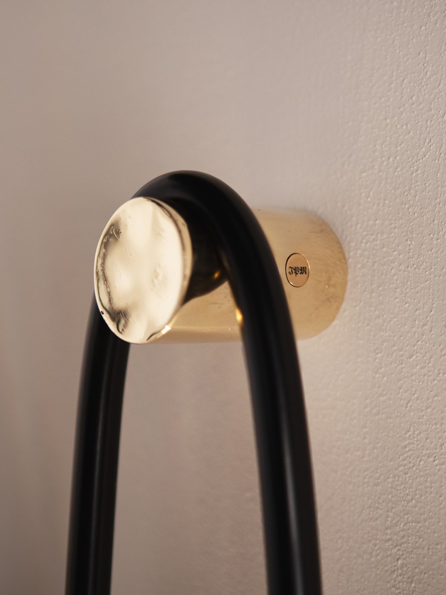 The lost-wax cast brass block that anchors the sconce to the wall