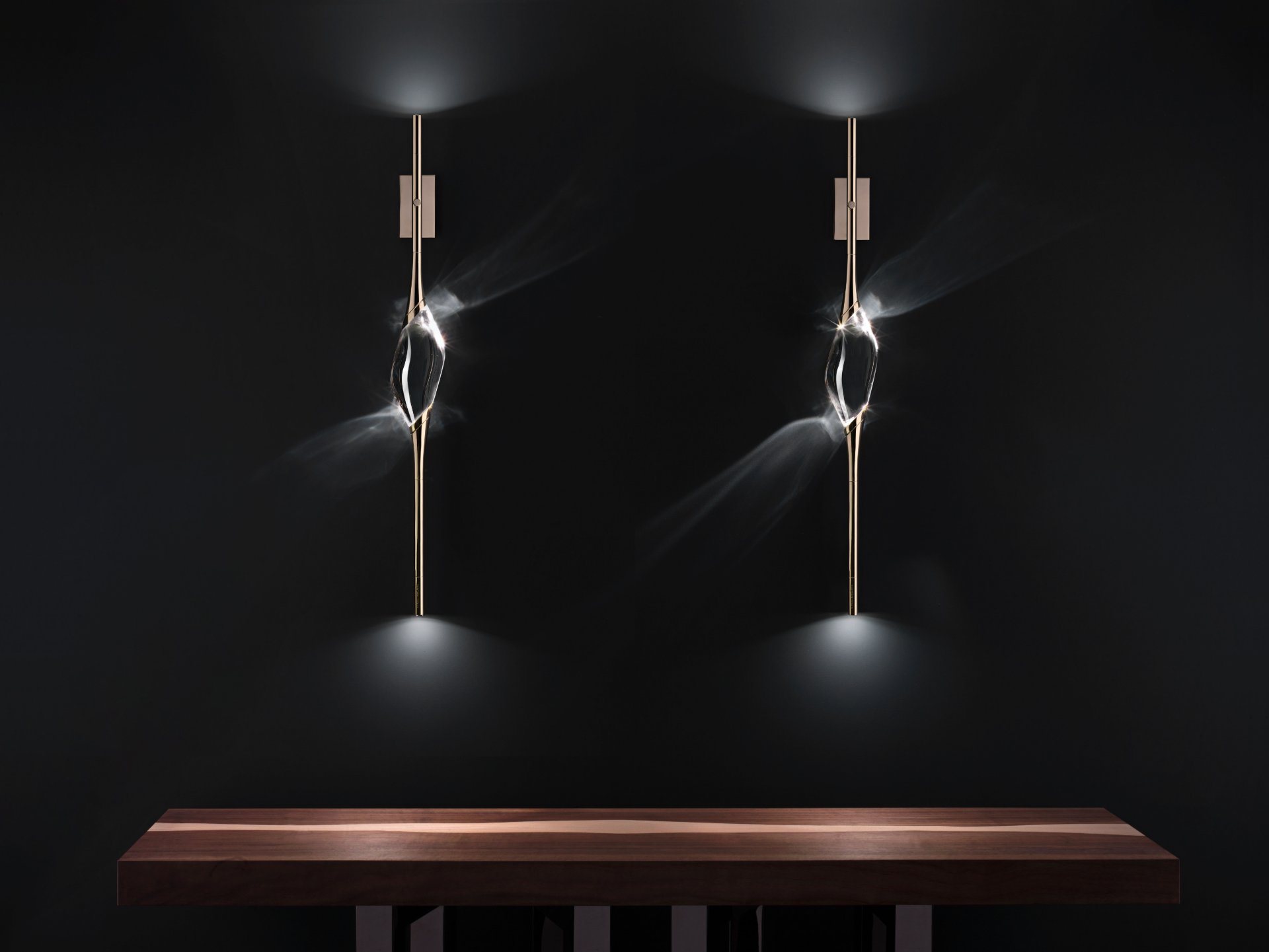 Two Il Pezzo 12 Wall Sconce lit in a pair above a wooden console