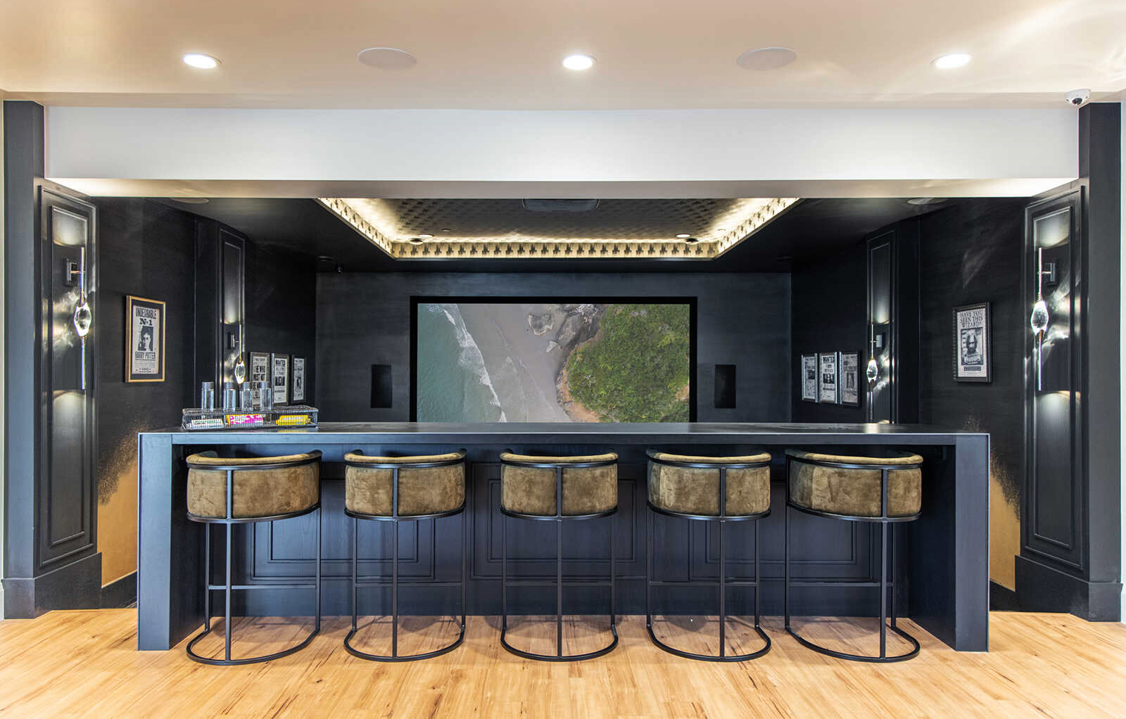 The media-room bar of The Baccarat, with two pairs of Il Pezzo 12 Wall Sconce on the dark walls