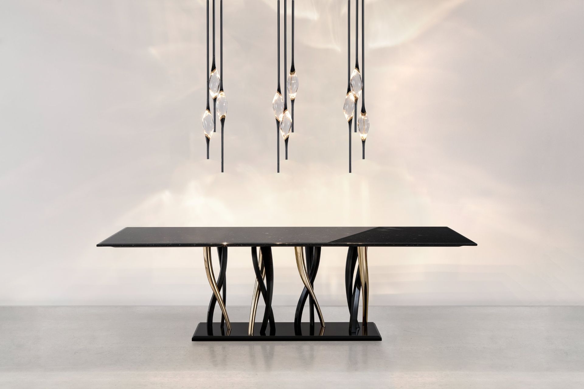 Three Il Pezzo 12 Round Chandeliers in a row over the Il Pezzo 8 marble table