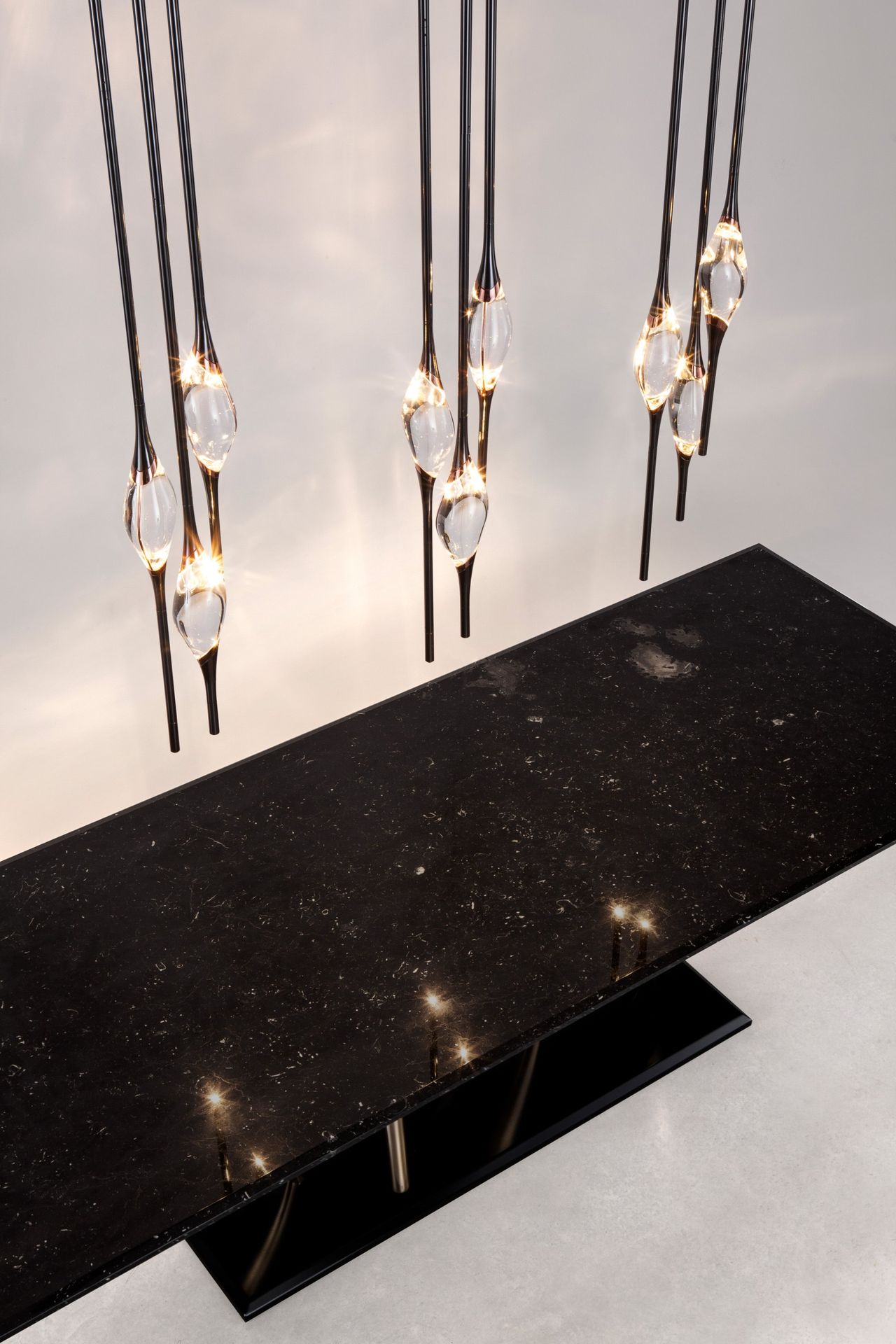 Il Pezzo 12 Round Chandelier over the Il Pezzo 8 marble table
