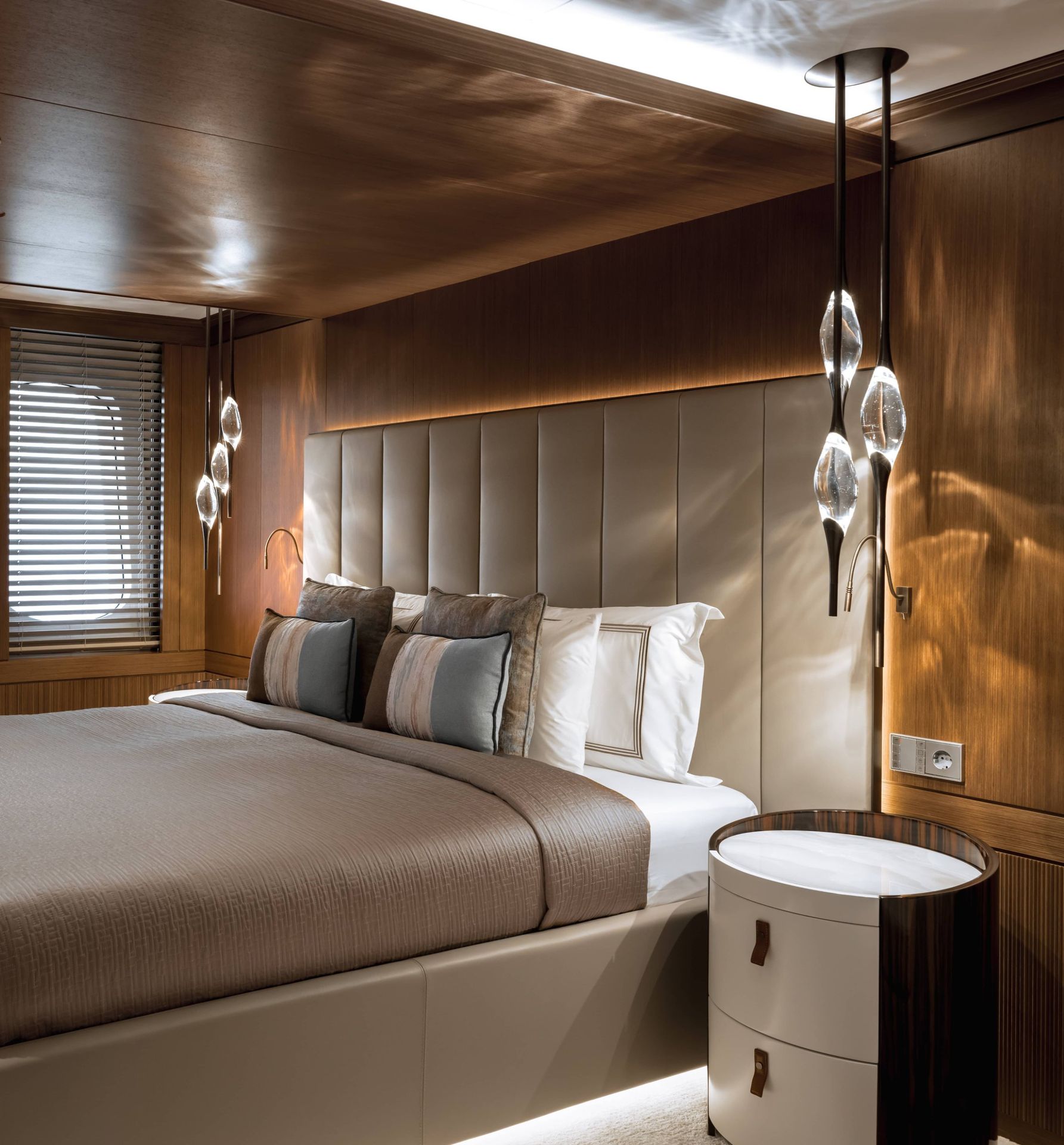 Two Il Pezzo 12 Round Chandeliers beside the bed of a guest cabin on the superyacht Victorious